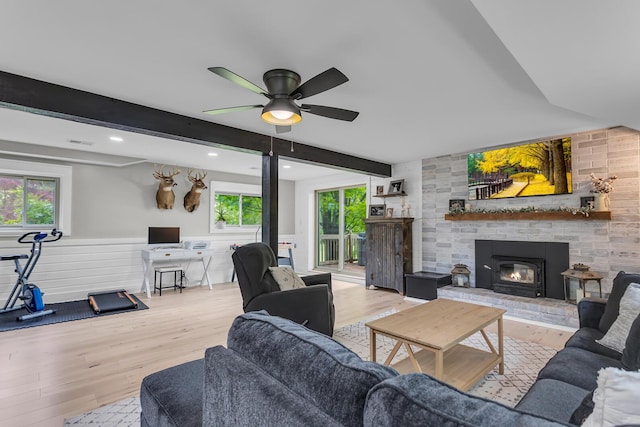 9275 M-50, Onsted, MI 49265 - living area featuring wood finished floors, a fireplace, ceiling fan, healthy amount of natural light, and beamed ceiling