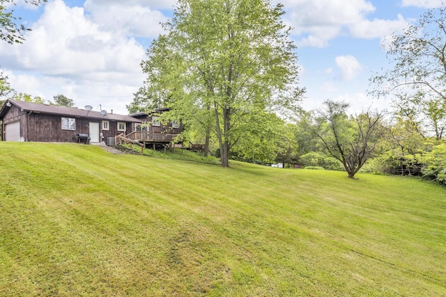 9275 M-50, Onsted, MI 49265 - view of green lawn featuring a wooden deck and an attached garage