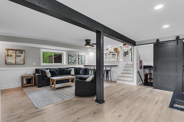 9275 M-50, Onsted, MI 49265 - living area featuring a barn door, light wood-style flooring, recessed lighting, ceiling fan, and wainscoting