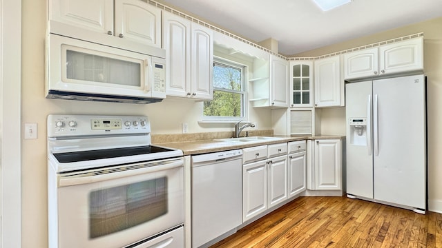 1972 W Cedar Dr, Mcbain, MI 49657 - kitchen featuring white appliances, a sink, white cabinets, light wood-type flooring, and light countertops