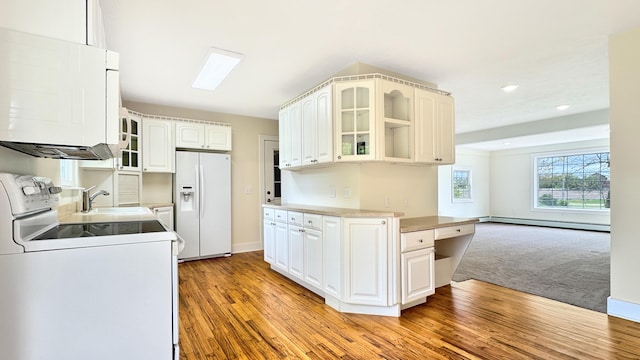 1972 W Cedar Dr, Mcbain, MI 49657 - kitchen with white appliances, a sink, a baseboard radiator, glass insert cabinets, and washer / dryer