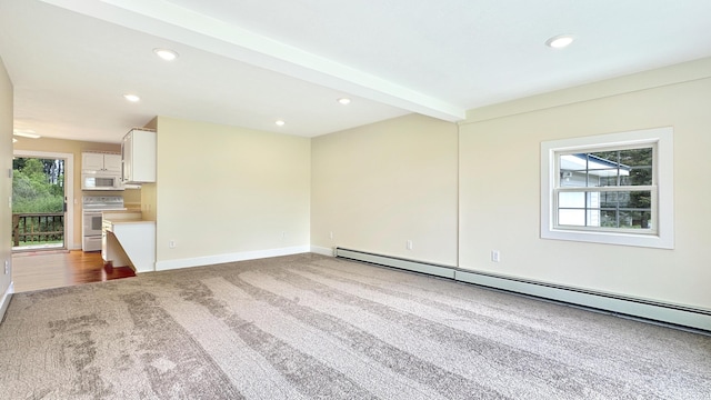 1972 W Cedar Dr, Mcbain, MI 49657 - unfurnished living room featuring carpet flooring, a baseboard heating unit, recessed lighting, and baseboards