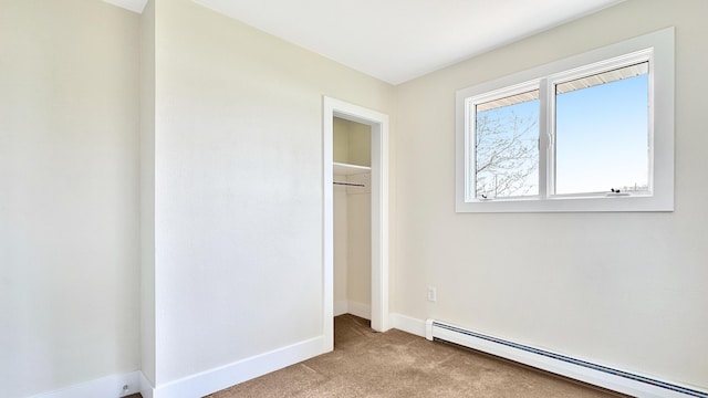 1972 W Cedar Dr, Mcbain, MI 49657 - unfurnished bedroom with baseboard heating, carpet, baseboards, and a closet