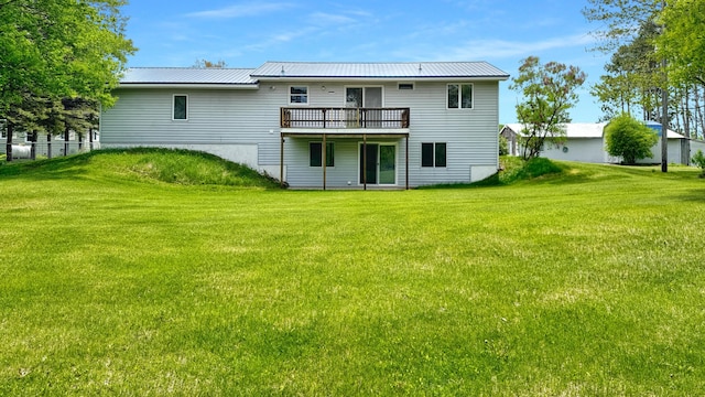 1972 W Cedar Dr, Mcbain, MI 49657 - rear view of property featuring a deck, a yard, and metal roof
