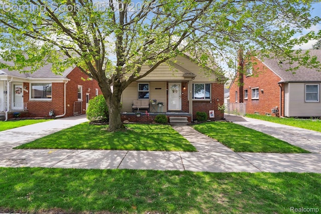 15645 Warwick Ave, Allen Park, MI 48101 - bungalow featuring brick siding, a front yard, and covered porch