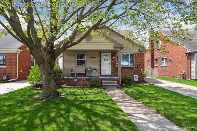 15645 Warwick Ave, Allen Park, MI 48101 - bungalow-style home featuring a porch, a front yard, and brick siding