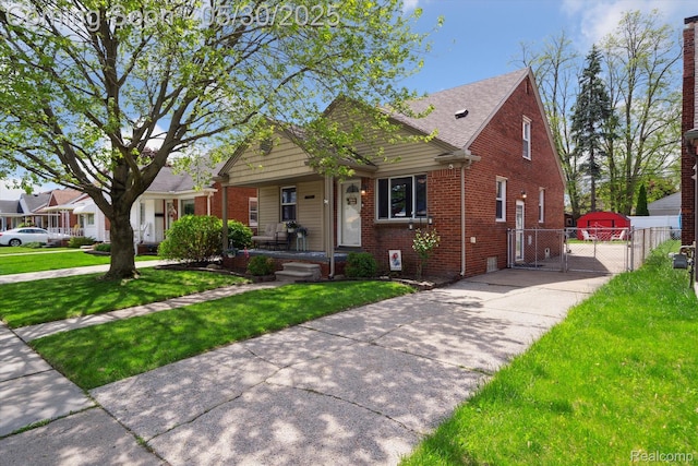 15645 Warwick Ave, Allen Park, MI 48101 - bungalow-style house with a gate, brick siding, and covered porch