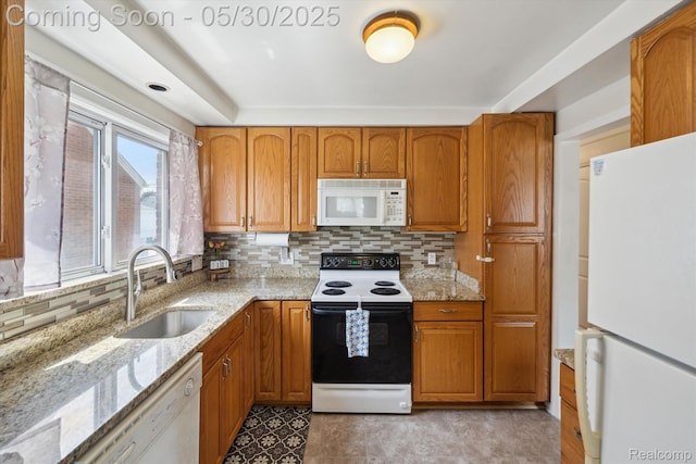 15645 Warwick Ave, Allen Park, MI 48101 - kitchen featuring white appliances, a sink, brown cabinetry, and tasteful backsplash