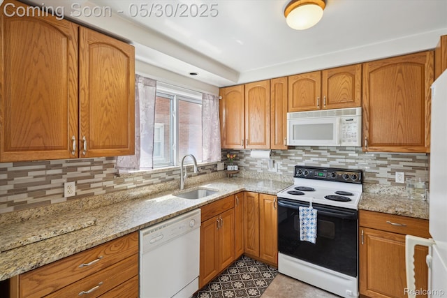 15645 Warwick Ave, Allen Park, MI 48101 - kitchen with white appliances, a sink, decorative backsplash, light stone countertops, and brown cabinets