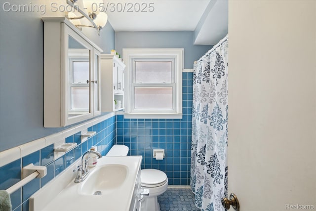 15645 Warwick Ave, Allen Park, MI 48101 - bathroom with toilet, tile walls, tile patterned floors, vanity, and wainscoting