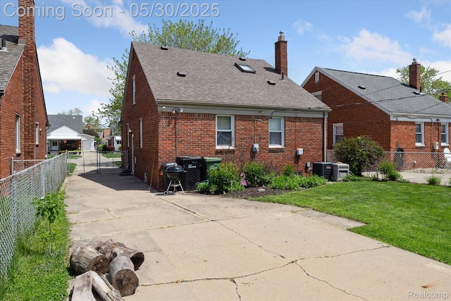 15645 Warwick Ave, Allen Park, MI 48101 - rear view of house with brick siding, roof with shingles, cooling unit, and a chimney