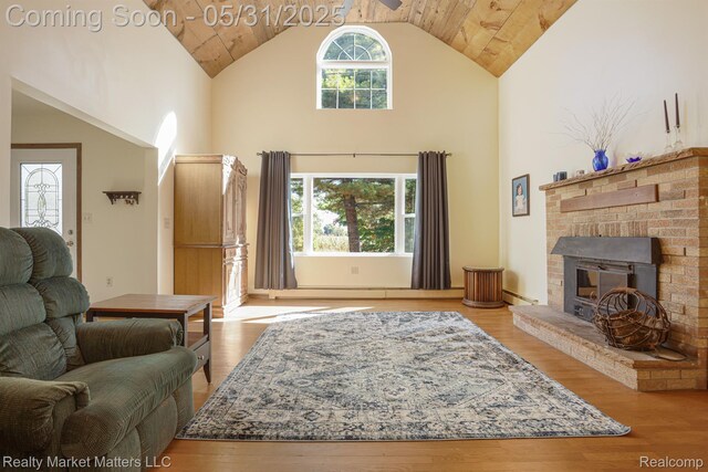 1831 Roods Lake Rd, Lapeer, MI 48446 - living area with high vaulted ceiling, wood finished floors, wood ceiling, a brick fireplace, and baseboard heating