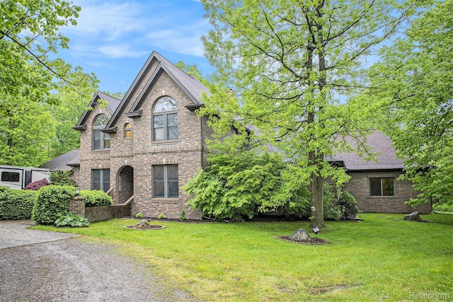 6140 Seymour Rd, Swartz Creek, MI 48473 - traditional-style home with brick siding, a front yard, and a shingled roof