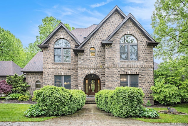 6140 Seymour Rd, Swartz Creek, MI 48473 - french country style house with brick siding and a shingled roof