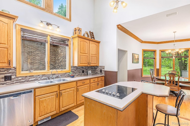 6140 Seymour Rd, Swartz Creek, MI 48473 - kitchen featuring stainless steel dishwasher, a sink, black electric cooktop, light wood-style floors, and a chandelier