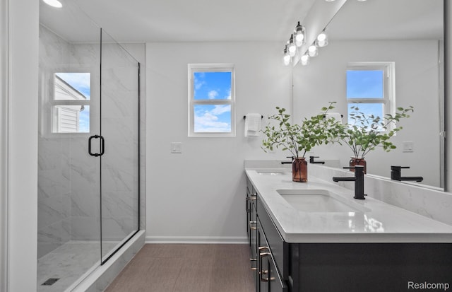 5555 E Spaniel Dr, Ann Arbor, MI 48108 - full bathroom featuring double vanity, a marble finish shower, and baseboards