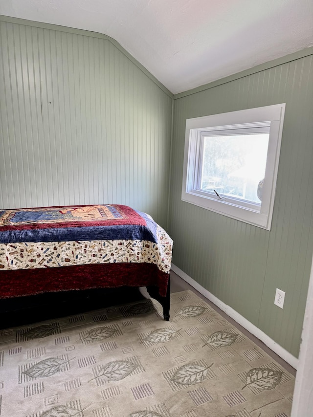 12227 Wise St, Bear Lake, MI 49614 - carpeted bedroom featuring lofted ceiling and baseboards