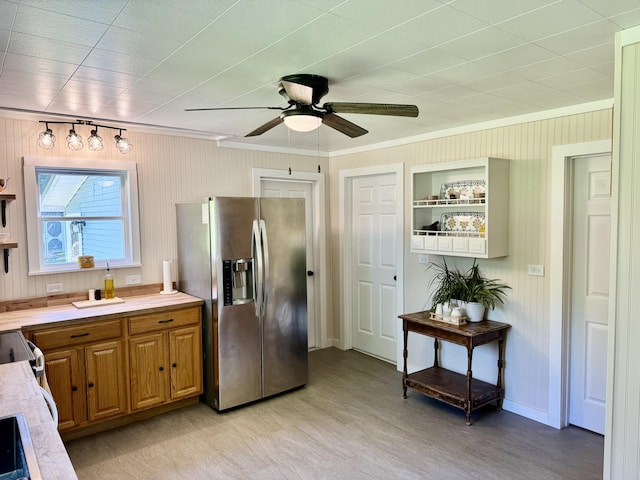 12227 Wise St, Bear Lake, MI 49614 - kitchen featuring stainless steel fridge, crown molding, light wood-style floors, a ceiling fan, and light countertops