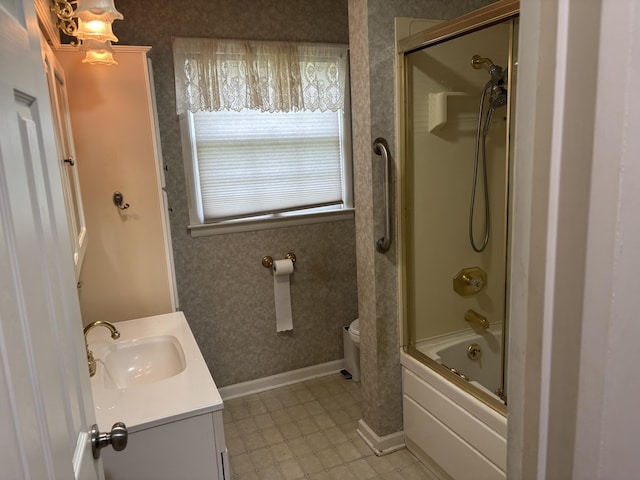 814 N Lakeview Ave, Sturgis, MI 49091 - bathroom with vanity, tile patterned flooring, toilet, shower / bath combination with glass door, and baseboards