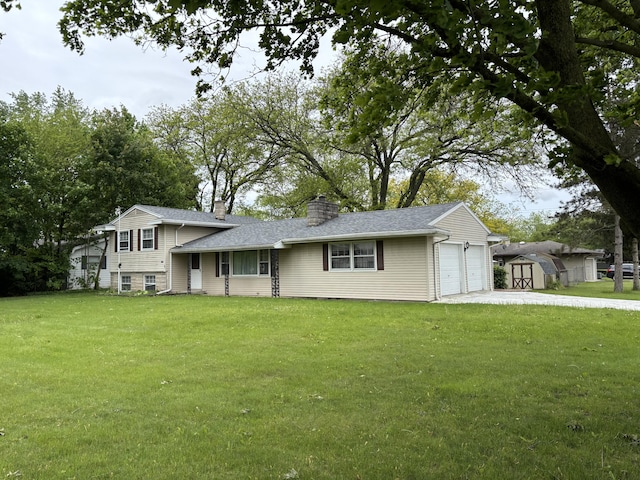 814 N Lakeview Ave, Sturgis, MI 49091 - split level home featuring a front lawn, a chimney, an attached garage, driveway, and a shingled roof
