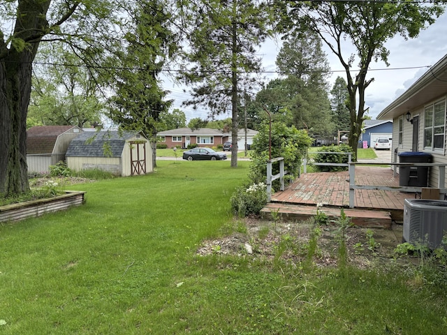 814 N Lakeview Ave, Sturgis, MI 49091 - view of grassy yard featuring central AC unit and a deck
