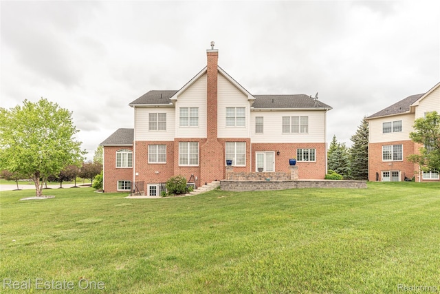 15390 Prestwick Cir, Northville, MI 48168 - rear view of house featuring a chimney, a yard, and brick siding