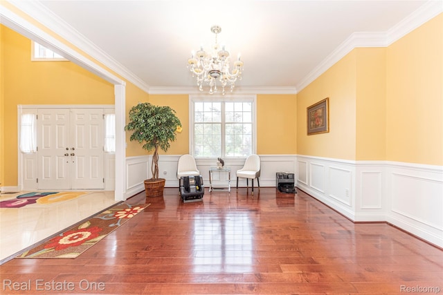 15390 Prestwick Cir, Northville, MI 48168 - foyer featuring a chandelier, ornamental molding, hardwood / wood-style floors, and wainscoting