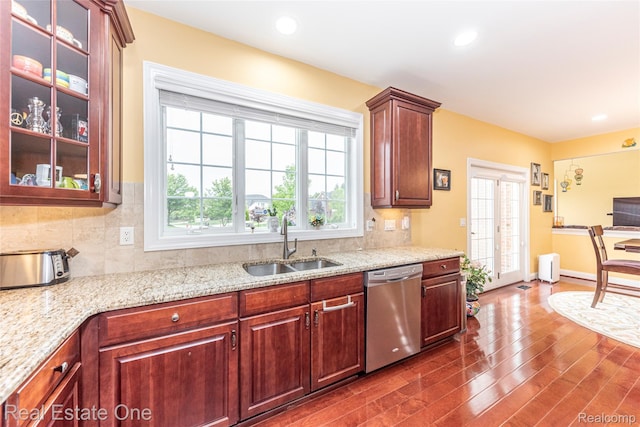 15390 Prestwick Cir, Northville, MI 48168 - kitchen featuring stainless steel dishwasher, a sink, dark wood-style flooring, healthy amount of natural light, and recessed lighting
