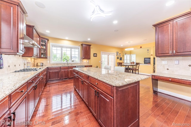 15390 Prestwick Cir, Northville, MI 48168 - kitchen featuring a sink, dark wood-style floors, a kitchen island, stainless steel gas cooktop, and recessed lighting