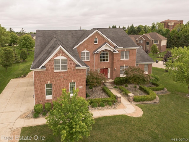 15390 Prestwick Cir, Northville, MI 48168 - view of front of home featuring brick siding, a front lawn, and a shingled roof