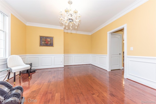 15390 Prestwick Cir, Northville, MI 48168 - unfurnished room with crown molding, hardwood / wood-style flooring, a chandelier, plenty of natural light, and a wainscoted wall