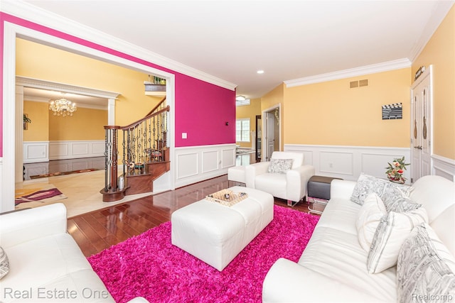 15390 Prestwick Cir, Northville, MI 48168 - living room with stairs, wood-type flooring, crown molding, a wainscoted wall, and a decorative wall