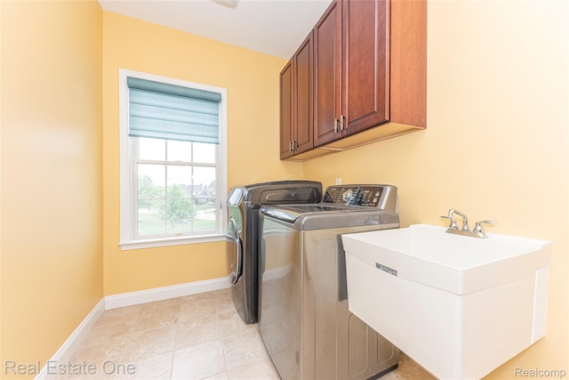 15390 Prestwick Cir, Northville, MI 48168 - laundry room featuring cabinet space, washer and dryer, baseboards, and light tile patterned floors