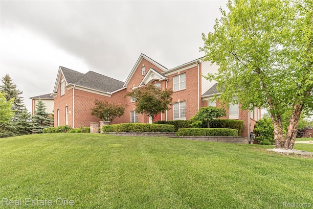 15390 Prestwick Cir, Northville, MI 48168 - view of front facade with brick siding, a front lawn, and roof with shingles
