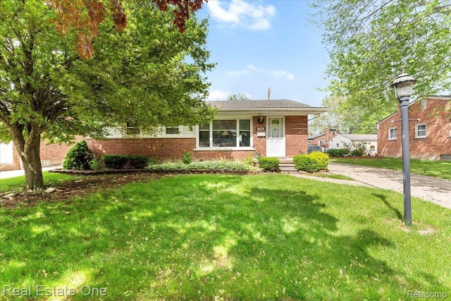8424 Roosevelt St, Taylor, MI 48180 - view of front facade with brick siding and a front lawn