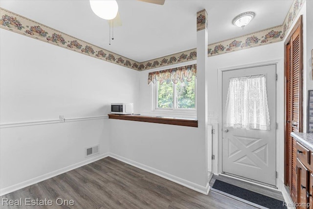 8424 Roosevelt St, Taylor, MI 48180 - foyer entrance with dark wood-style flooring, baseboards, and ceiling fan