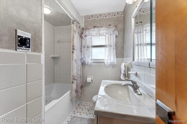 8424 Roosevelt St, Taylor, MI 48180 - full bath with tile walls, vanity, shower / bath combo, and toilet