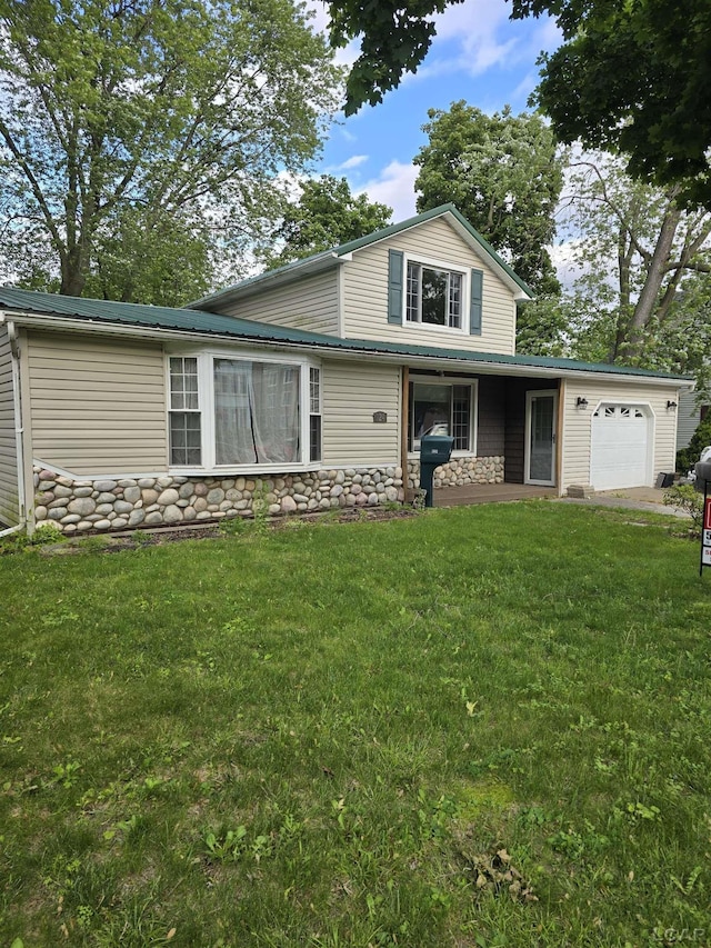 124 N Madison St, Adrian, MI 49221 - view of front facade with a garage, a front lawn, and stone siding