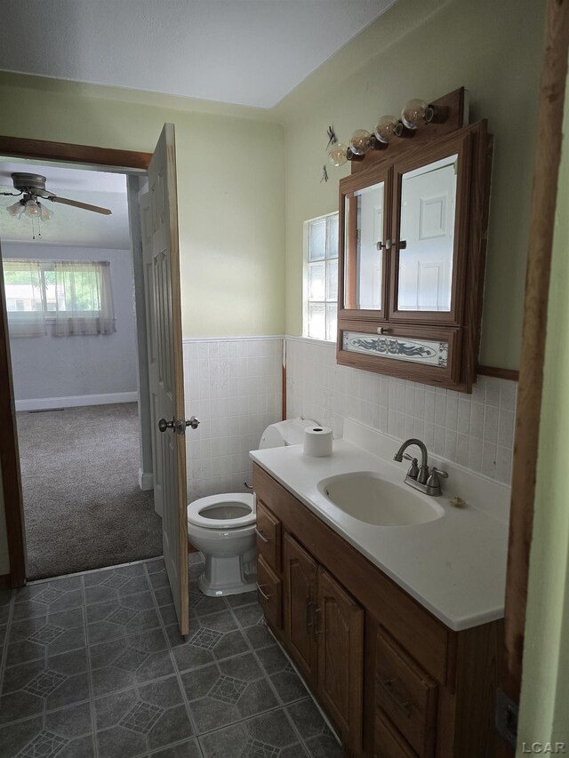 124 N Madison St, Adrian, MI 49221 - half bathroom with vanity, ceiling fan, tile walls, and wainscoting