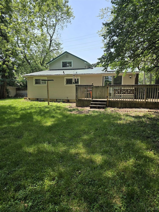 124 N Madison St, Adrian, MI 49221 - rear view of house with a deck, a yard, and a metal roof