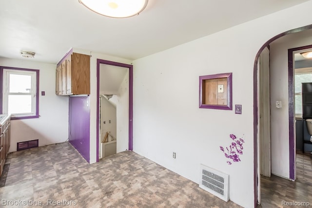 725 E Sherman St, Holly, MI 48442 - kitchen with arched walkways and brown cabinets
