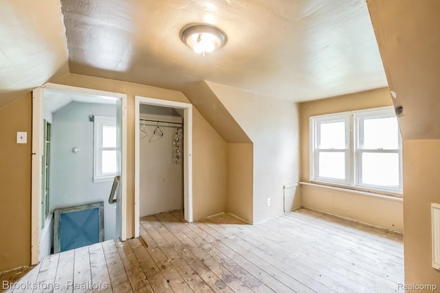 725 E Sherman St, Holly, MI 48442 - bonus room featuring hardwood / wood-style floors, vaulted ceiling, and healthy amount of natural light