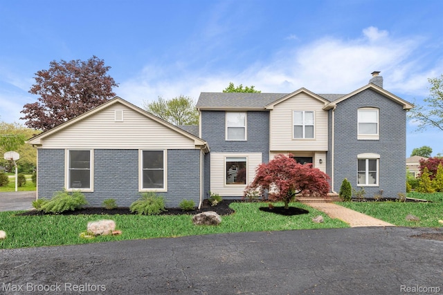 4573 Ranch Ln, Bloomfield Hills, MI 48302 - view of front facade with a chimney, brick siding, and a front yard