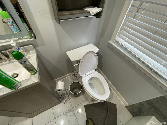 13960 Mettetal St, Detroit, MI 48227 - bathroom featuring toilet, vanity, and marble look tiles