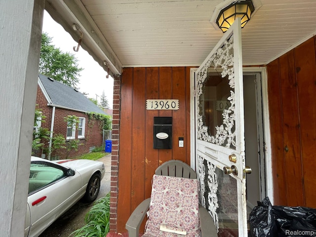 13960 Mettetal St, Detroit, MI 48227 - doorway to property featuring board and batten siding