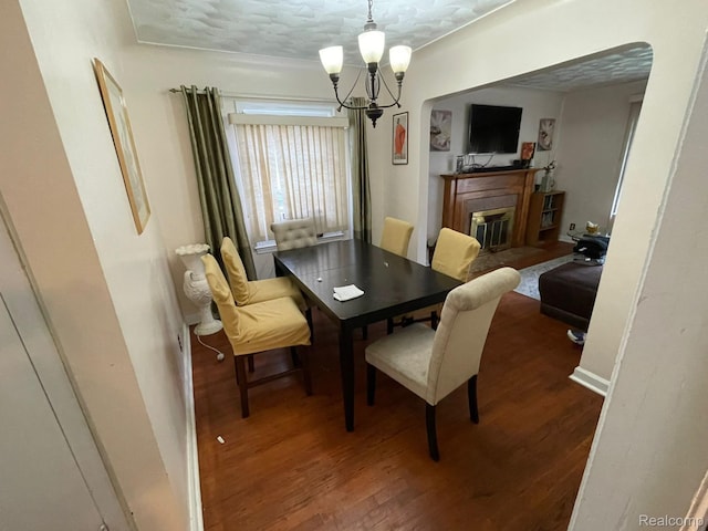 13960 Mettetal St, Detroit, MI 48227 - dining space with a fireplace with flush hearth, wood finished floors, and a chandelier