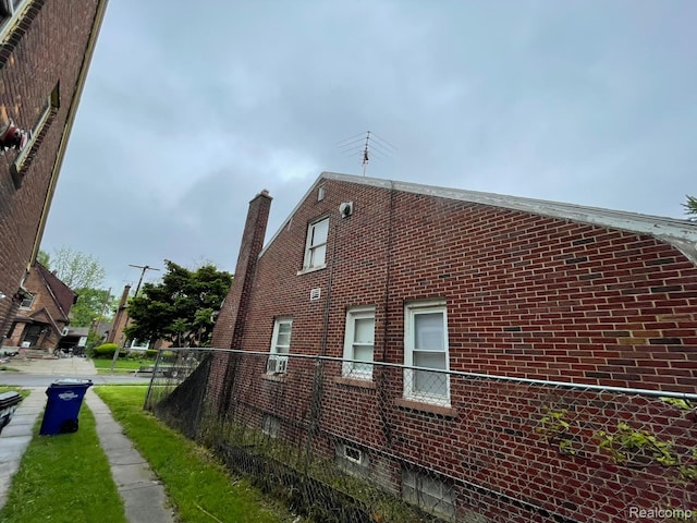 13960 Mettetal St, Detroit, MI 48227 - view of home's exterior with brick siding and a chimney