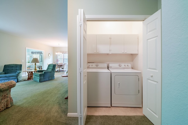 5610 Copper Sands Run, Fruitport, MI 49415 - laundry room featuring light colored carpet, washer and clothes dryer, a chandelier, and cabinet space