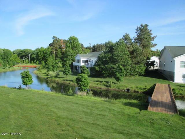 5610 Copper Sands Run, Fruitport, MI 49415 - view of green lawn with a water view