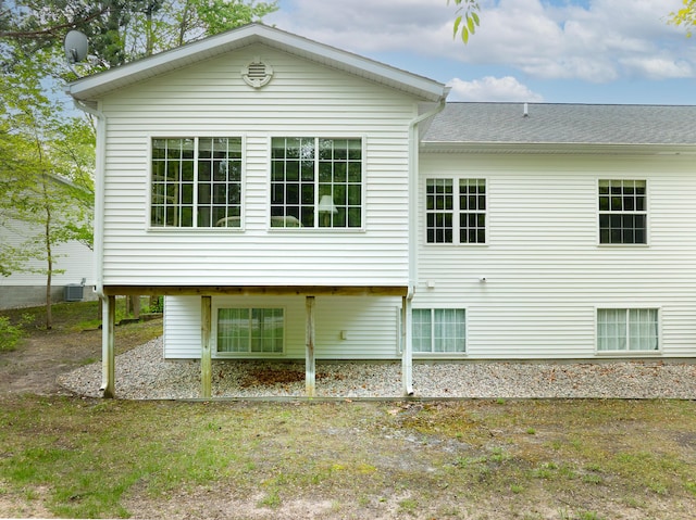 5610 Copper Sands Run, Fruitport, MI 49415 - rear view of property featuring central AC unit and roof with shingles